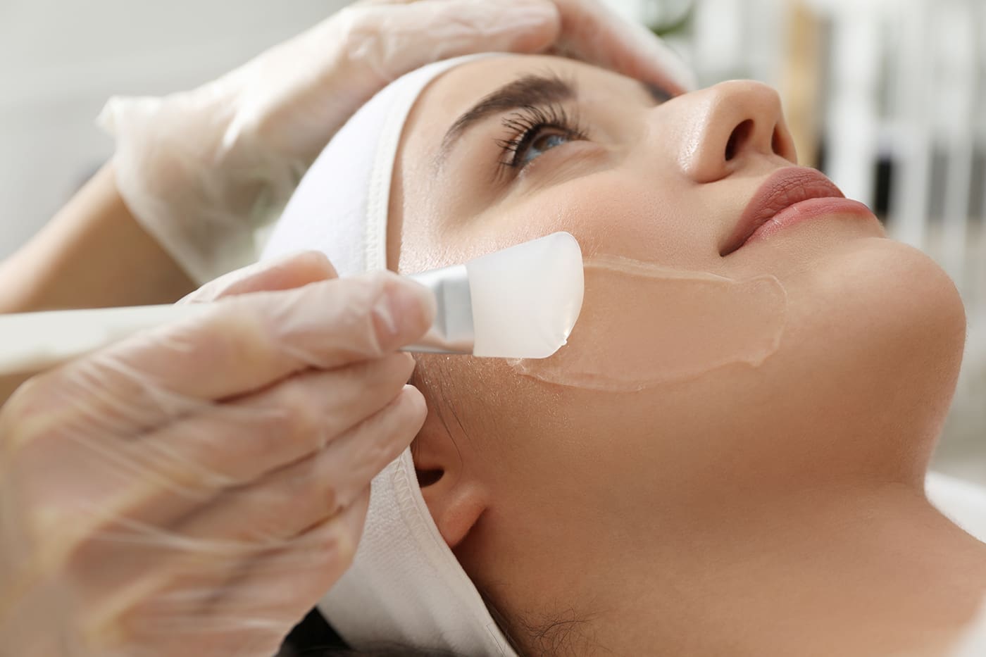 Young woman during chemical peel at Kontour by Belita Savage, closeup