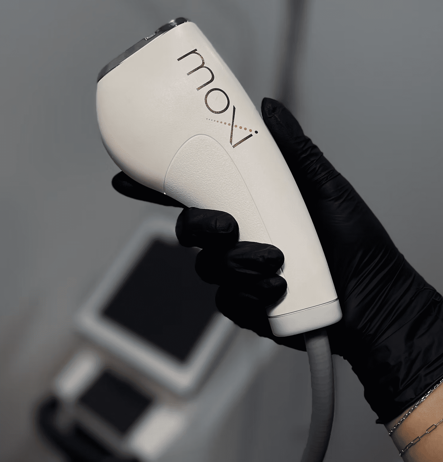 woman holding moxi laser machine