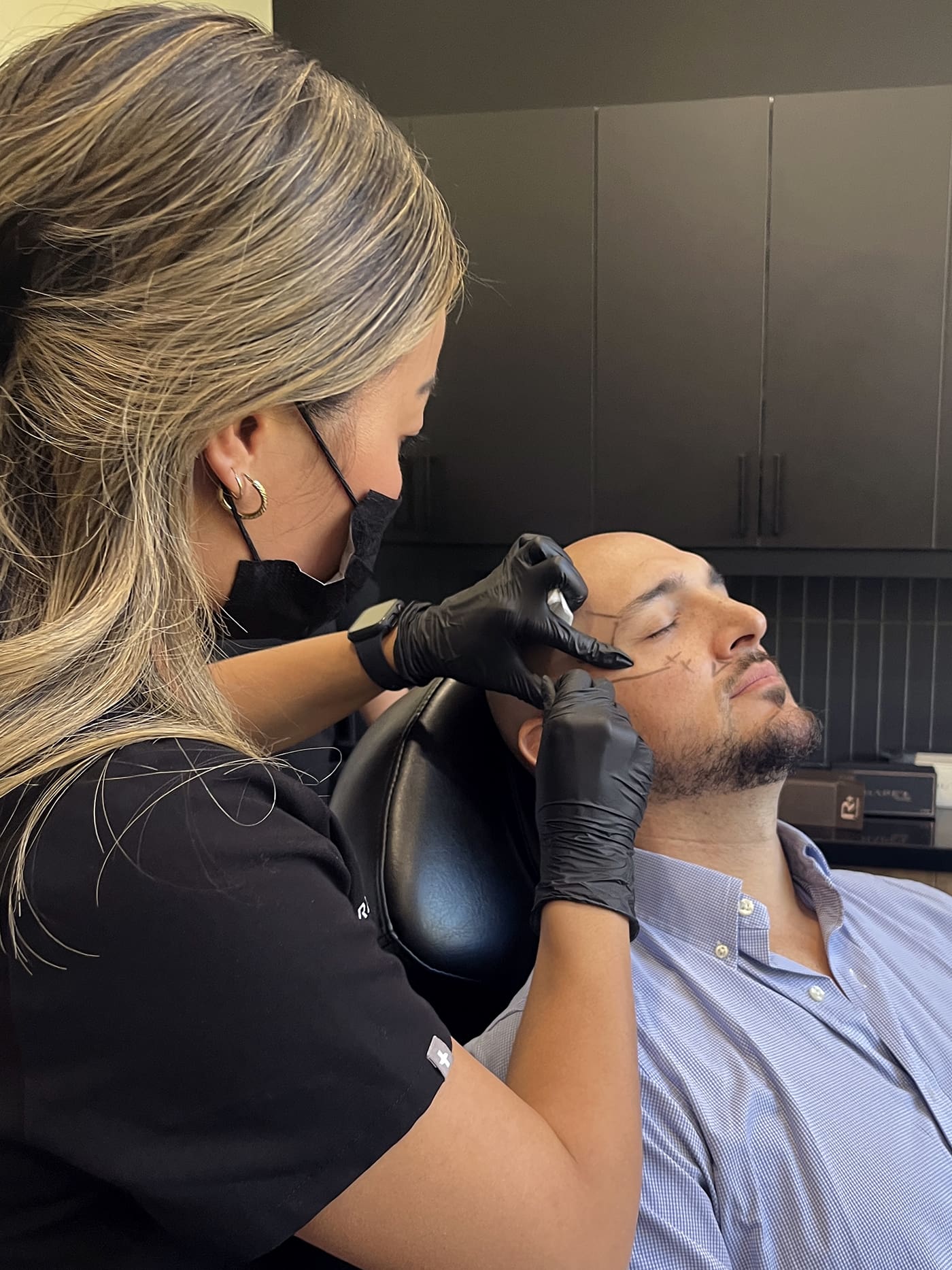 belita savage marking up a mans face before botox