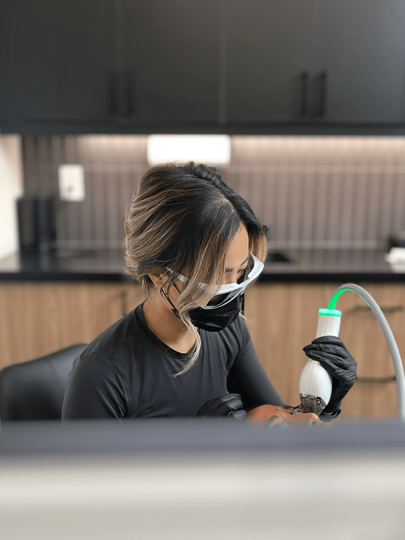 Belita Savage using a moxi laser on a patient
