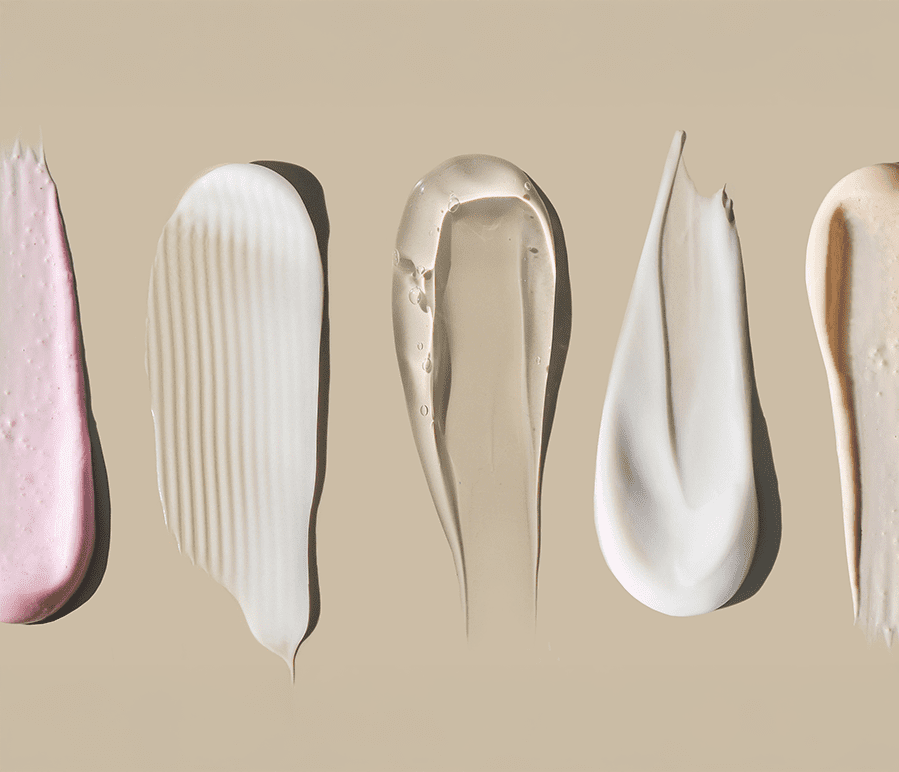 prescription skin care creams spread out on beige surface